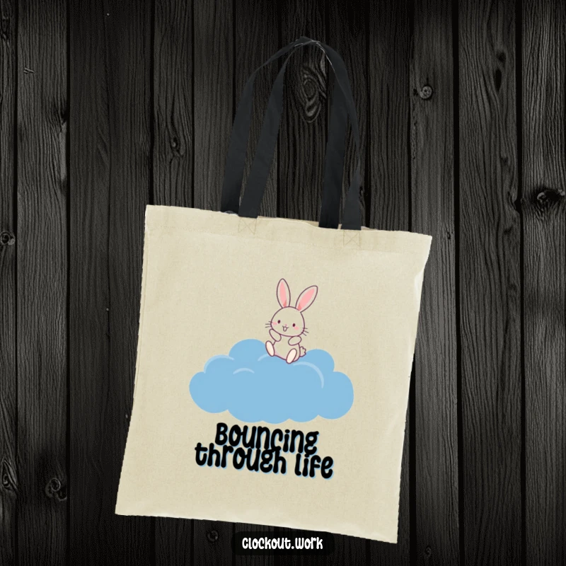 Funny Tote Bag with a happy rabbit bouncing on a fluffy dark blue cloud, ideal for carrying daily items.